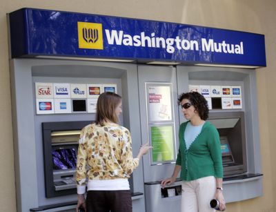 Two Washington Mutual customers use an ATM at a branch in Palo Alto, Calif. Shares of Washington Mutual Inc. have been volatile this week, as anxiety grows on Wall Street over the financial stability of the nation’s largest thrift and its options for survival.  (Associated Press / The Spokesman-Review)