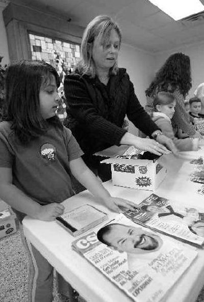 
From left, volunteers Andrea Cutsail and Renata Freel help prepare Lifeboxes for soldiers in Iraq for the New River Baptist Association in Jacksonville, N.C. The Lifeboxes include Christian magazines. 
 (Associated Press / The Spokesman-Review)