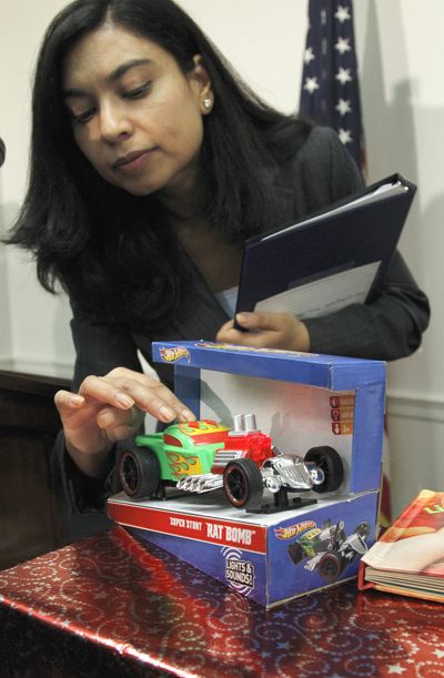 Nasima Hossain demonstrates a toy that has high noise levels during a news conference Tuesday on dangerous or toxic toys. (Associated Press)