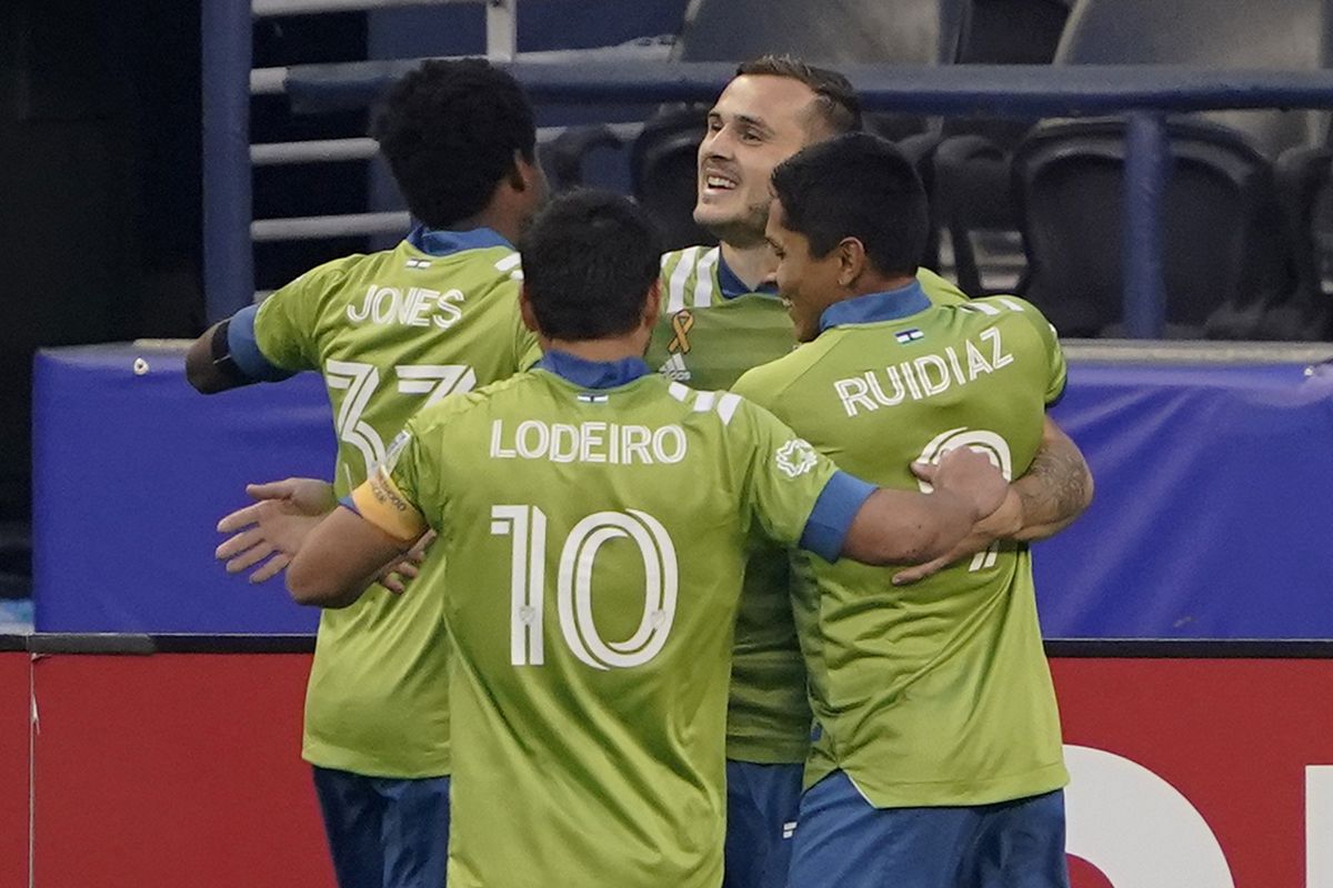 Seattle Sounders’ Jordan Morris, facing, celebrates with teammates Raul Ruidiaz and Nico Lodeiro after Morris scored a first-half goal against the San Jose Earthquakes on Sept. 10 in Seattle.  (Associated Press)