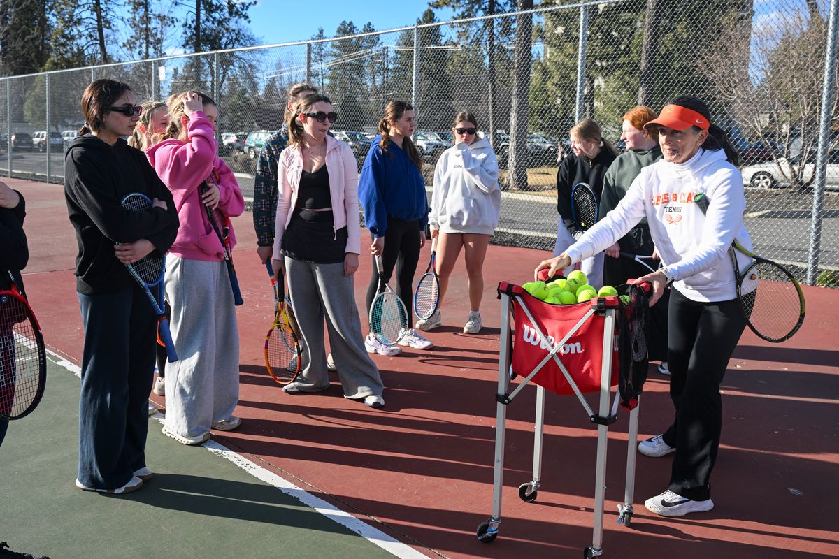 Lewis and Clark High School coach Kate Burns, right, organizes drills to engage her large turnout of tennis players at practice at Hart Field recently.  (Jesse Tinsley/The Spokesman-Review)