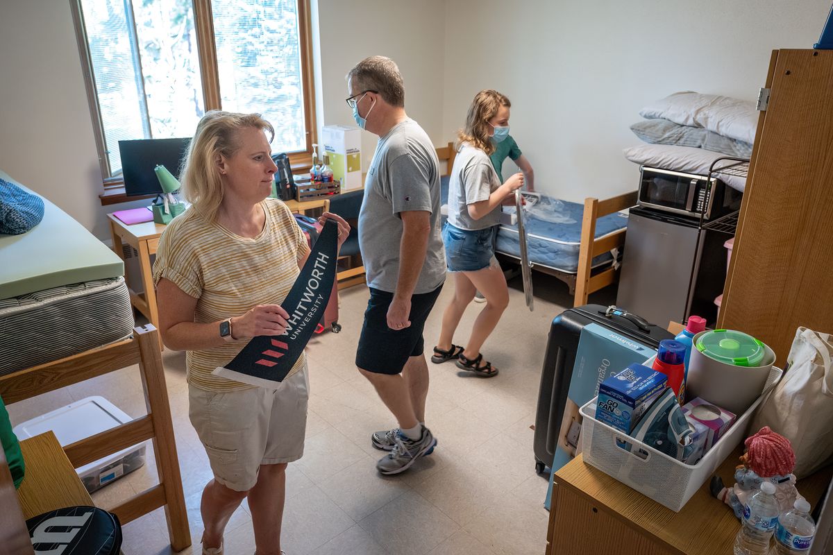 During move-in day, Mom and dad Stan and Teresa Lewis help their freshman daughter, Britney, 18, move into her dorm room in Arend Hall on the Whitworth University campus, Saturday, September 4, 2021. Whitworth University is welcoming one of its largest classes of incoming first-year and transfer students, close to 650 students, this fall.  (COLIN MULVANY/THE SPOKESMAN-REVI)