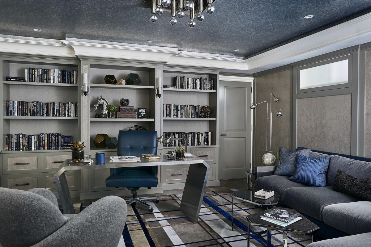 This undated photo provided by Jenny Kirschner shows a basement designed by the New York-based interior designer. Details like crown molding and built-in shelving give this basement home office a glamorous feel fit for any room of the house. (Ryan Dausch / AP)