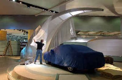 
Karl Fielden of H.B. Stubbs, an exhibit producer, pulls back the covering on a Buick display at the North American International Auto Show in Detroit. The company's redesigned Buick display is geared to reaching out to a 