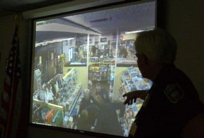 
 Deputy Police Chief Al Odenthal narrates a security camera video in July from the Zip Trip store where police tried to arrest Otto Zehm on March 18. 
 (File / The Spokesman-Review)