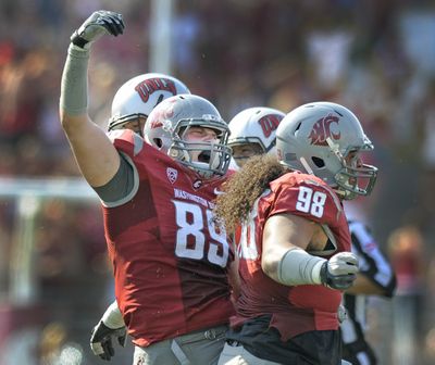 WSU defensive end Travis Long (89) celebrates with teammate Kalafitoni Pole( 98) after they combined to sack the UNLV quarteback during their game at Martin Stadium in Pullman, Saturday, Sept. 10, 2011. (Christopher Anderson / Spokesman-Review)
