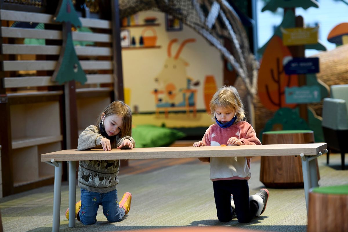 Penny Walter, 3, left and Beatrix Tucker, 4, play in the kids area during the opening of the new Liberty Park Library on Friday, Nov. 12, 2021.  (Kathy Plonka/The Spokesman-Review)