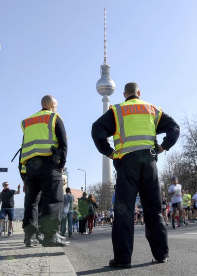 Police guard during the half marathon run in Berlin, Sunday, April 8, 2018. (Christophe Gateau / Associated Press)