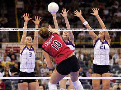 
Stanford's Kristin Richards (10) spikes toward UW's Courtney Thompson, Darla Myhre and Sanha Tomasevic (left to right). 
 (Associated Press / The Spokesman-Review)