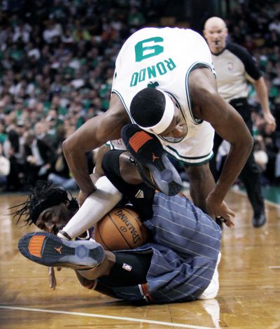 Boston’s Rajon Rondo, top, and Charlotte’s Gerald Wallace take a tumble while battling for the ball in the third quarter Wednesday.  (Associated Press / The Spokesman-Review)