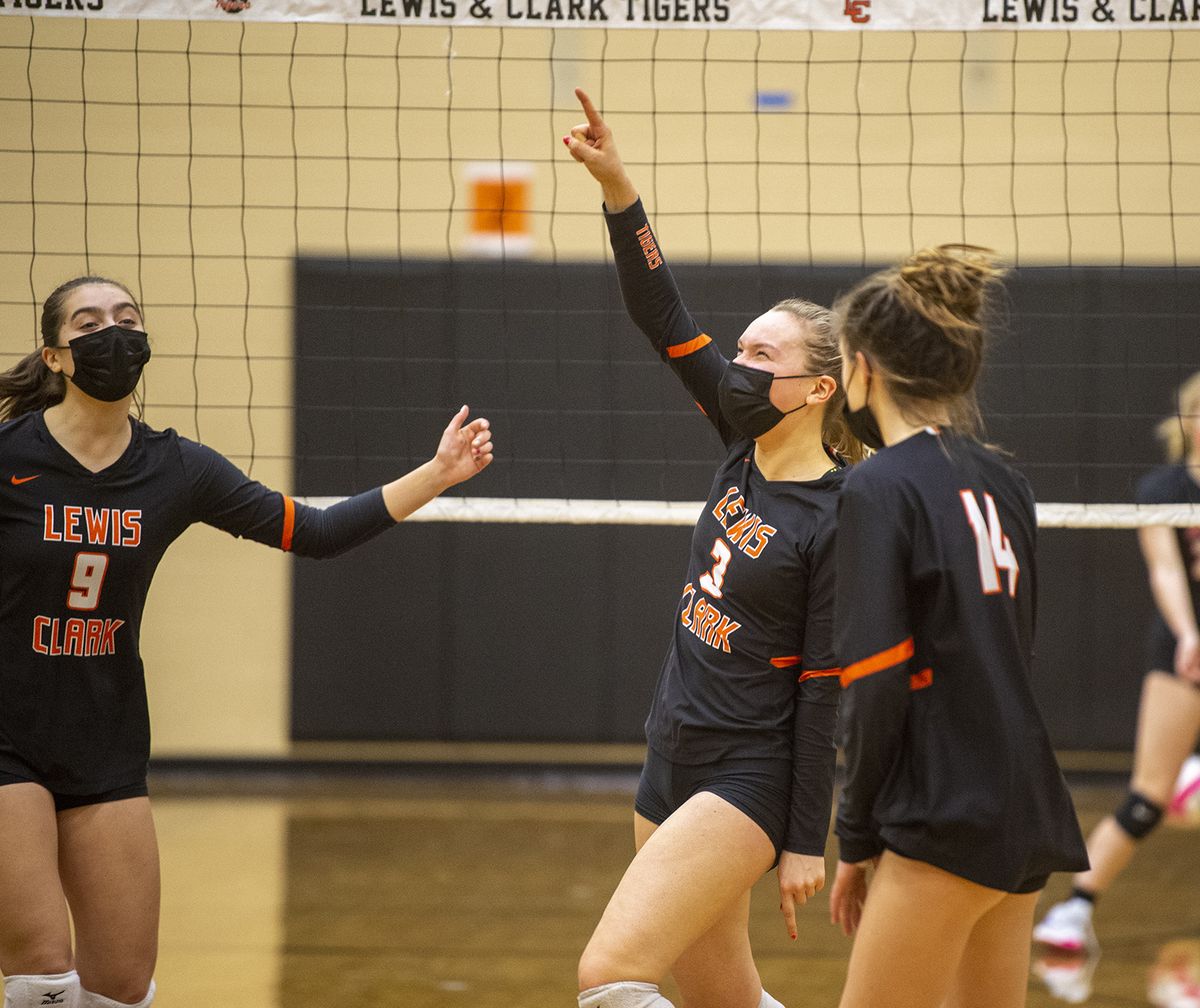 Lewis and Clark High School varsity setter Katie Henlein (3) celebrates winning the second game with teammates Hallie Brigham (9) and Ellie DeAndre (14) during a match against Ferris High School at LC Tuesday, Mar. 23, 2021.  (Jesse Tinsley/The Spokesman-Review)