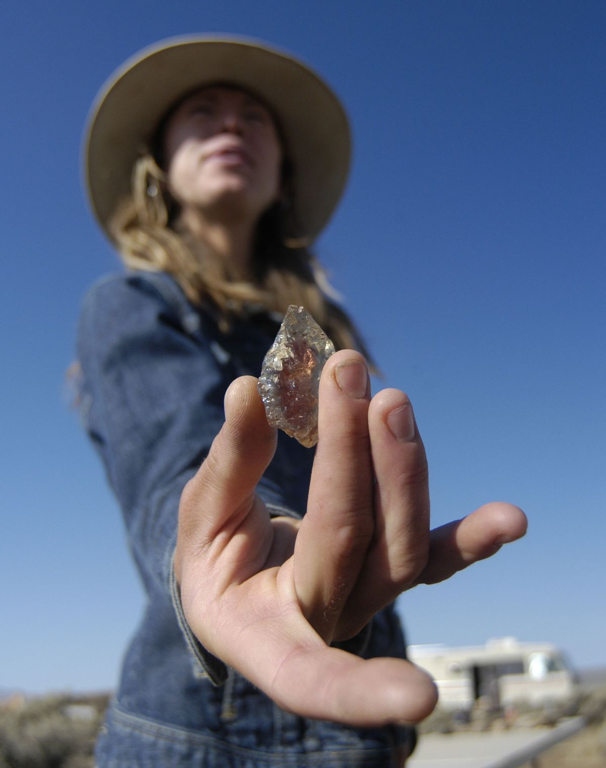 Spectrum Sunstone Mine manager Jessica Schenk holds a red-colored sunstone. Photos courtesy of Eugene Register-Guard (Photos courtesy of Eugene Register-Guard / The Spokesman-Review)
