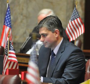 State Sen. Mike Baumgartner studies a bill at his desk in the Senate chamber. (Jim Camden)