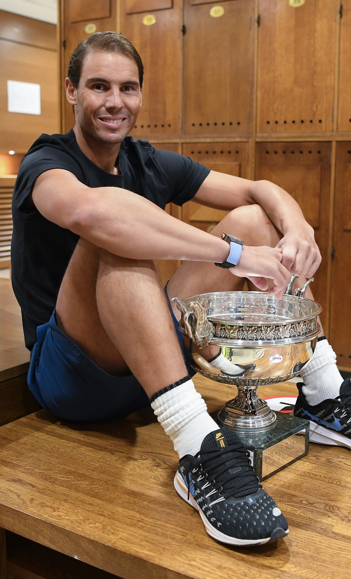 In this Sunday, Oct. 11, 2020 image provided by the French Tennis Federation FFT, Spain's Rafael Nadal poses with the trophy in the locker room after winning the final match of the French Open tennis tournament against Serbia's Novak Djokovic at the Roland Garros stadium in Paris, France.  (Julien Crosnier)