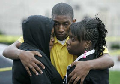 
Family members hug outside the SuccessTech Academy in Cleveland on Wednesday after a 14-year-old student on suspension opened fire at the alternative school, injuring four. Associated Press
 (Associated Press / The Spokesman-Review)
