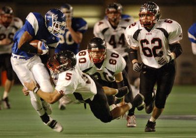 Archbishop Murphy's Shiloh Keo tackles Pullman senior Ashton Gant during the Greyhounds' 28-24 win in Saturday's State 2A football championship game at the Tacoma Dome.
(Kevin Nibur/ / The Spokesman-Review)