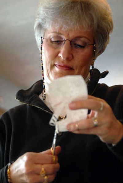 
Ginger Collins  cuts a design into paper with special scissors while working on a scherenschnitte piece at her Spokane Valley home Tuesday.
 (Photos by Holly Pickett / The Spokesman-Review)