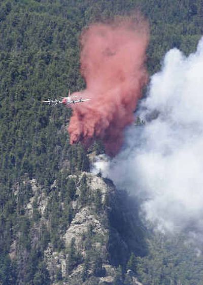 
A plane drops retardant on the Mount Graham fire Monday. 
 (Associated Press / The Spokesman-Review)