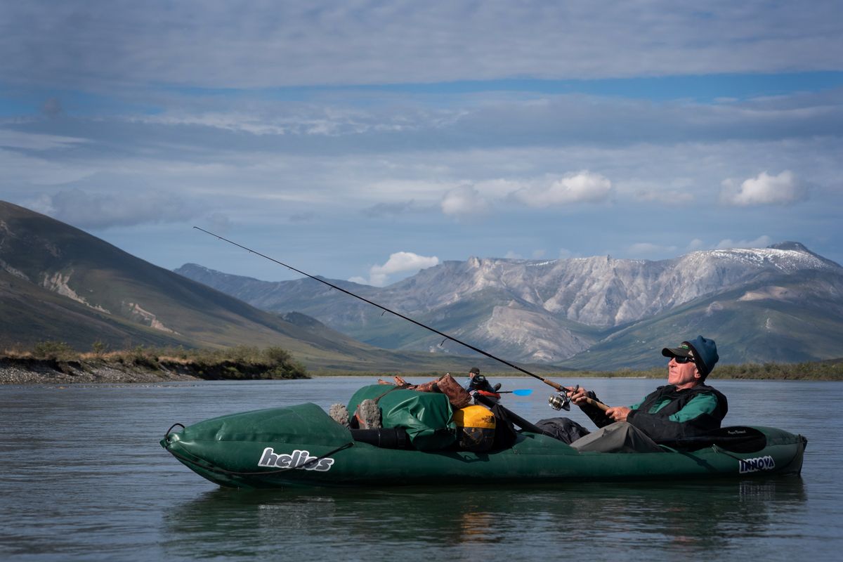 Cary Kopczynski fishes while paddling down the Noatak River on July 30.  (Eli Francovich/The Spokesman-Review)