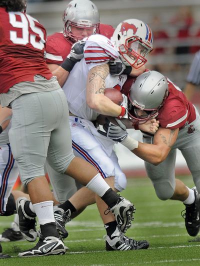 Washington State’s defense smothers and sacks Southern Methodist quarterback Bo Levi Mitchell during  Sept. 19, 2009 game in Pullman. Mitchell has transferred from SMU to Eastern Washington University. (Christopher Anderson / The Spokesman-Review)