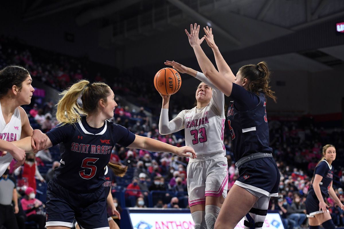 Gonzaga forward Melody Kempton, who scored 17 points, heads to the basket against Saint Mary’s guard Madeline Holland (5) and forward Ali Bamberger on Thursday.  (COLIN MULVANY/THE SPOKESMAN-REVIEW)