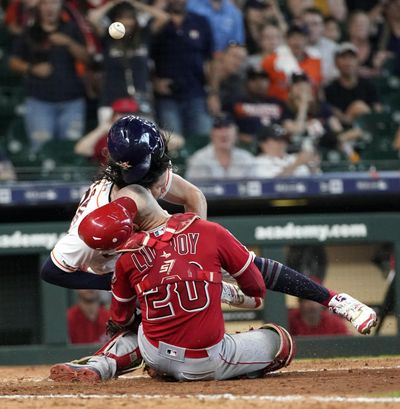 Houston Astros’ Jake Marisnick, right, collides Los Angeles Angels catcher Jonathan Lucroy (20) while trying to score during the eighth inning of a baseball game Sunday, July 7, 2019, in Houston. Marisnick was called out under the home plate collision rule. (David J. Phillip / Associated Press)