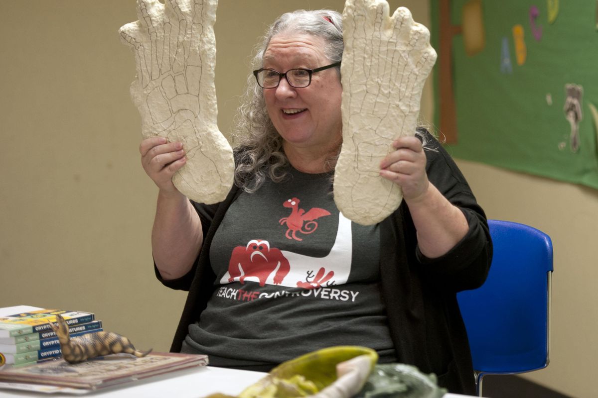 Kelly Milner Halls holds a set of Bigfoot track castings during a discussion about cryptozoology at Spokane Valley Library on Tuesday, Oct. 23, 2019. (Kathy Plonka / The Spokesman-Review)