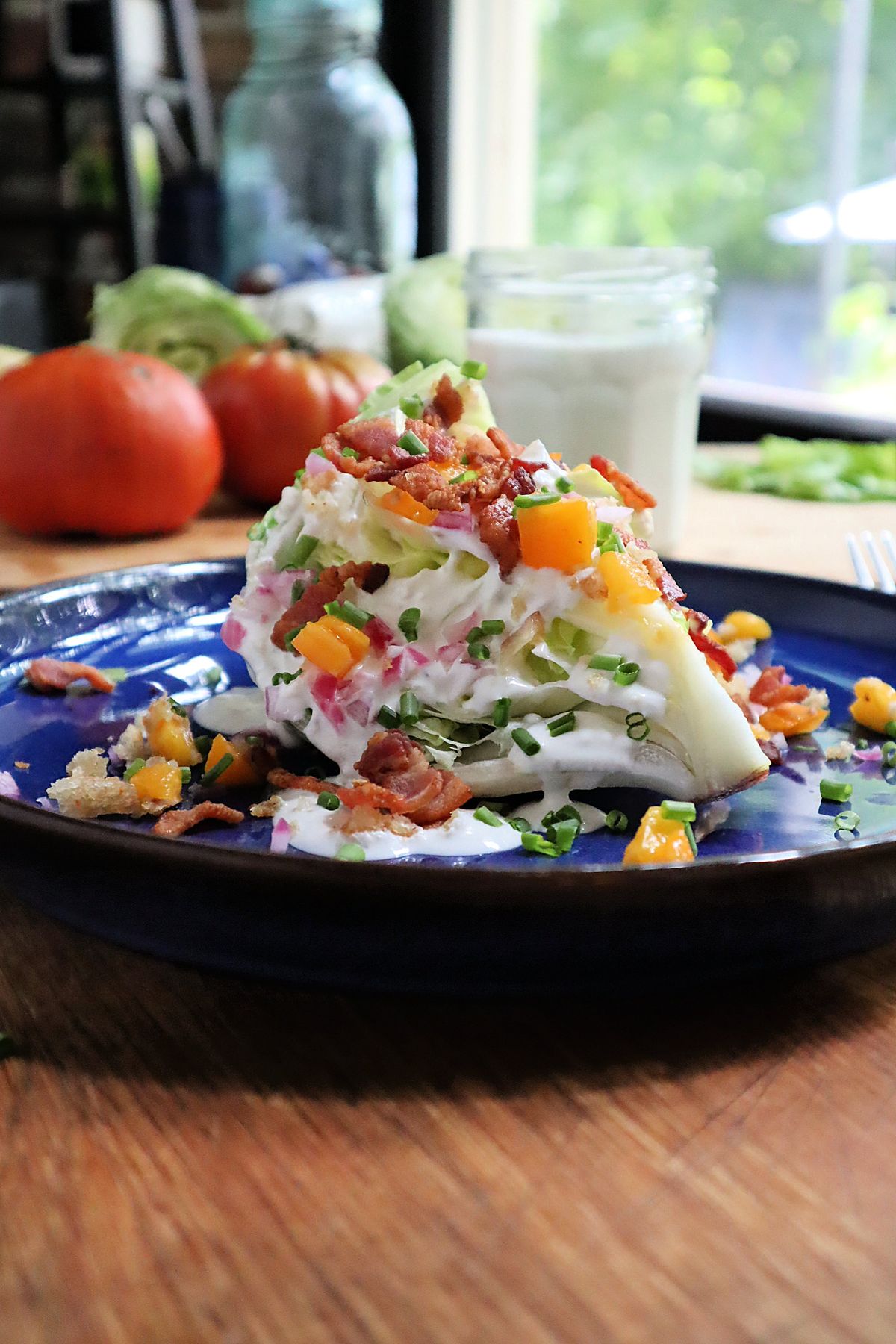 A towering iceberg wedge salad topped with crumble bacon and blue cheese dressing is a classic steakhouse side.  (Gretchen McKay/Pittsburgh Post-Gazette/TNS)