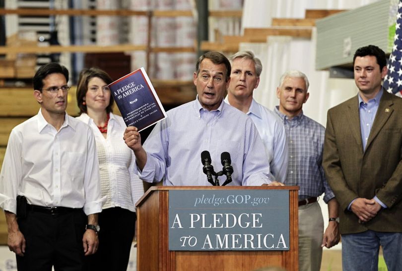 House Minority Leader John Boehner of Ohio, center, holds up a copy of the GOP agenda, 