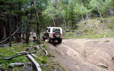 
 A Jeep driver navigates rough terrain on a designated route inside the Helena National Forest in Montana. Some routes on public lands will be closed to prevent erosion and protect wildlife.
 (File/Associated Press / The Spokesman-Review)