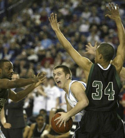 
Central Valley Bears' Conner Janhunen, center, looks for an opening, but is about to have the ball stripped away by Franklin Quakers' Jordan Daisy, left, while being guarded by Zach Williams during the first half of the 4A WIAA Championship basketball game Saturday in Tacoma.
 (Photos courtesy of Jim Bryant / The Spokesman-Review)