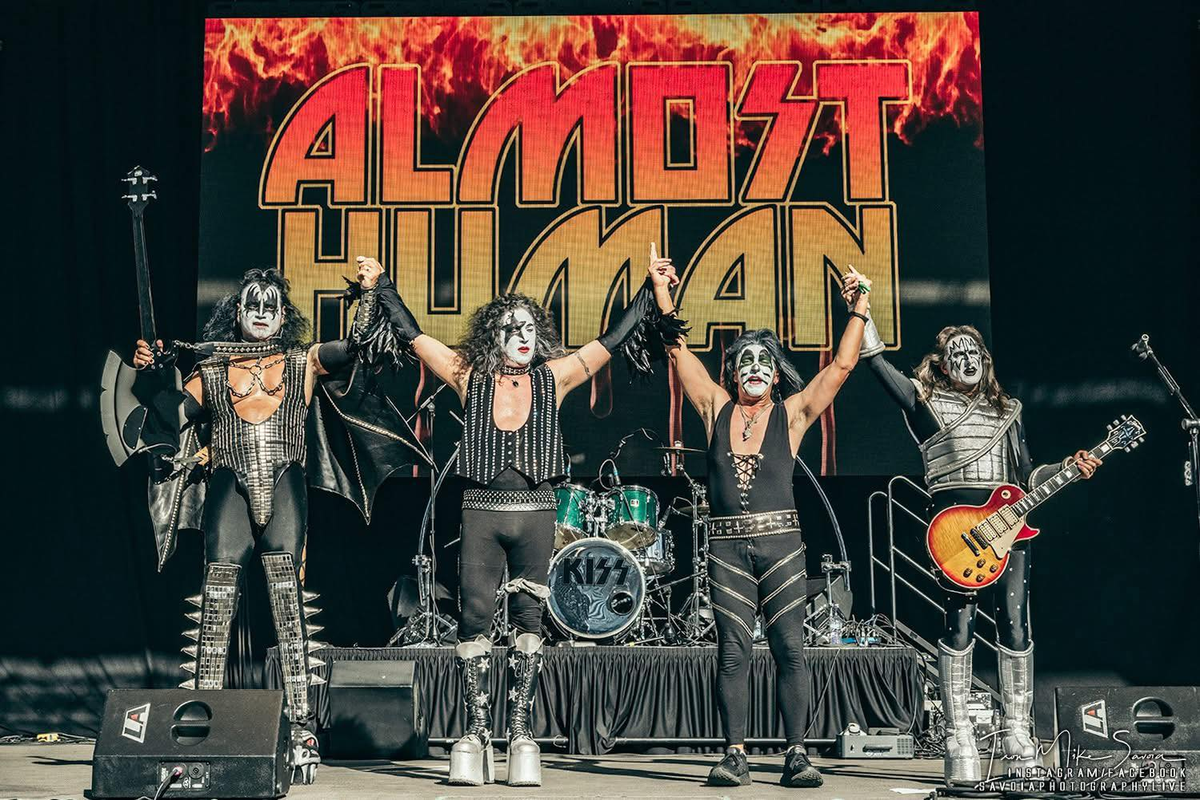 Almost Human KISS tribute band members Joe Dredd, left, Chris Bewick, Scott Hunt and Paul Orrico greet fans at a Taste Northwest event. (Courtesy)