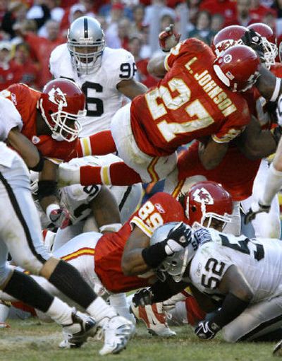 
Chiefs running back Larry Johnson (27) dives into the end zone as time expires for a game-winning touchdown on Sunday. 
 (Associated Press / The Spokesman-Review)