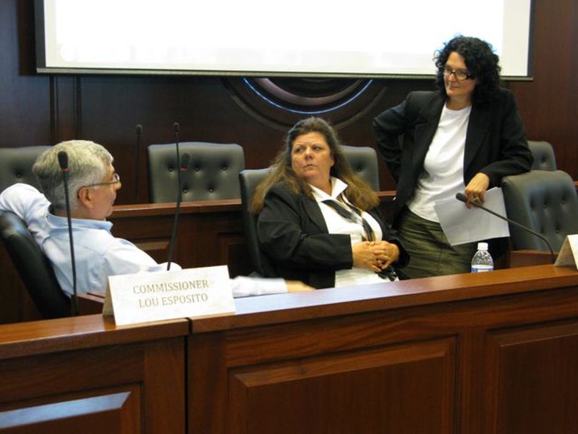 Redistricting Commissioners Lou Esposito, left, Lorna Finman, center, and Julie Kane, right, confer during a break in the commission's proceedings Tuesday afternoon, a scant hour before their deadline for drawing new legislative and congressional districts. (Betsy Russell)