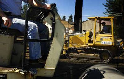 
Crews from Ground Works Construction and North Idaho College work to build a parking lot on Monday at the old Robin Hood RV Park site located on N. Lincoln Way. 
 (Jed Conklin / The Spokesman-Review)
