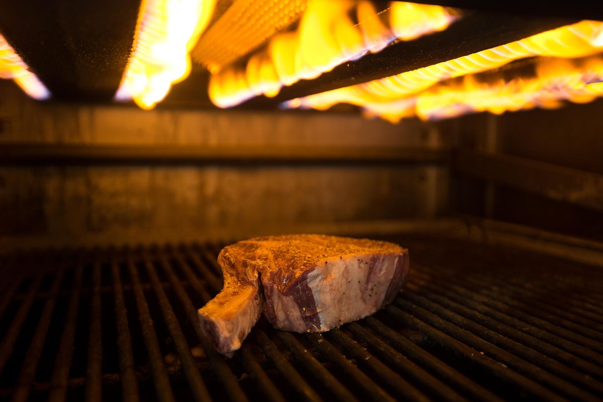 A steak is seen cooking at Spencer