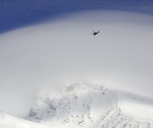 An Oregon National Guard Blackhawk helicopter flies over cloud-shrouded Mount Hood as the search for two missing climbers continues as seen from Timberline Lodge in Government Camp, Ore., Monday, Dec. 14, 2009. Weather conditions improved early in the day  allowing searchers a window of opportunity to search for Anthony Vietti, 24, of Longview, Wash., and Katie Nolan, 29, of Portland, before a large winter storm blows in later in the day. (Don Ryan / Associated Press)