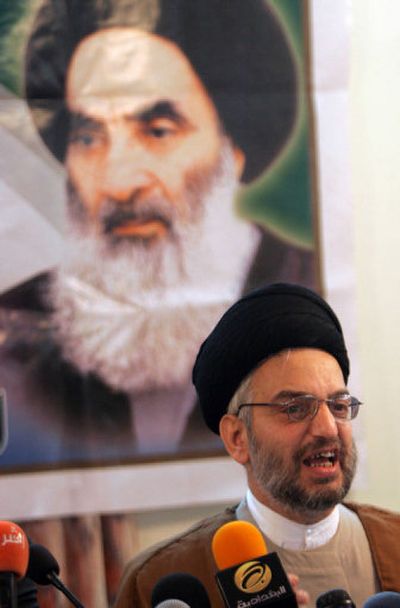 
With a poster of Grand Ayatollah Ali al-Sistani, Iraq's top Shiite cleric, in the background,  Shiite politician Abdul-Aziz al-Hakim presents his joint Shiite ticket to reporters Saturday in Baghdad.
 (Associated Press / The Spokesman-Review)