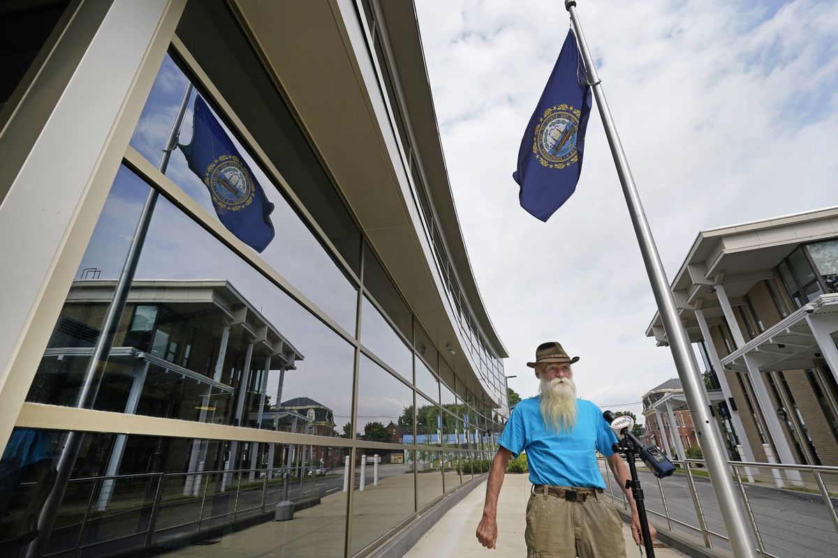 David Lidstone, an off-the-grid New Hampshire hermit known to locals as "River Dave," speaks to media outside Merrimack County Superior Court after a status conference hearing, Wednesday, Aug. 11, 2021, in Concord, N.H. The court determined that Lidstone will be able to collect his cats, chickens, and remaining possessions from the site he has lived on for 27 years. Lidstone, who still believes he was not on private land, also was given permission to hire a surveyor to give him "peace of mind," Judge Andrew Schulman said.  (Elise Amendola)