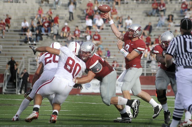 WSU quarterback Kevin Lopina throws a swing pass during second-half action against Stanford on Saturday in Pullman. (Christopher Anderson / The Spokesman-Review)