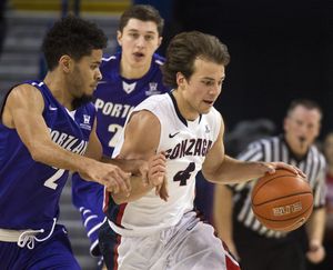Gonzaga Bulldogs guard Kevin Pangos (4) heads downcourt as Portland Pilots guard Alec Wintering (2) defends, in the second half of a men's  college basketball game, Thursday, Jan. 29, 2015, in the McCarthey Athletic Center. (Colin Mulvany / The Spokesman-Review)