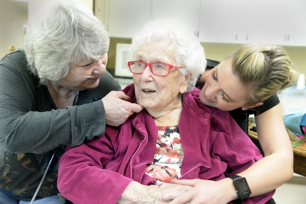 Flossie Dickey, who turns 110 today, is visited by her granddaughter, Jerry Carver, left, and great-granddaughter Sarah Williamson at Cheney Care Center on Monday. (Jesse Tinsley / The Spokesman-Review)