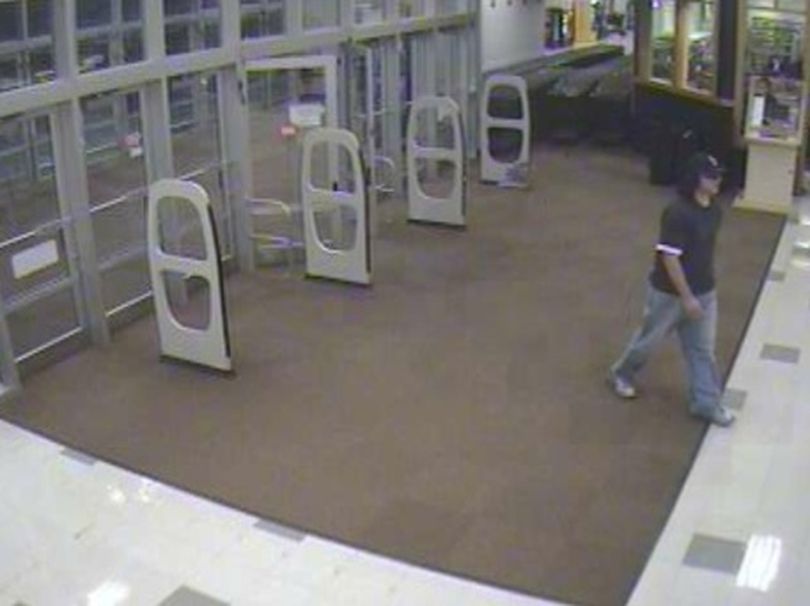 Surveillance photo of a pharmacy robbery at the South Regal Street ShopKo 9:42 p.m. Aug. 24, 2009. The robber is described as a white male in his 20s with dark stubble and approximately 6 feet, 3 inches tall. (Courtesy of Crime Stoppers)