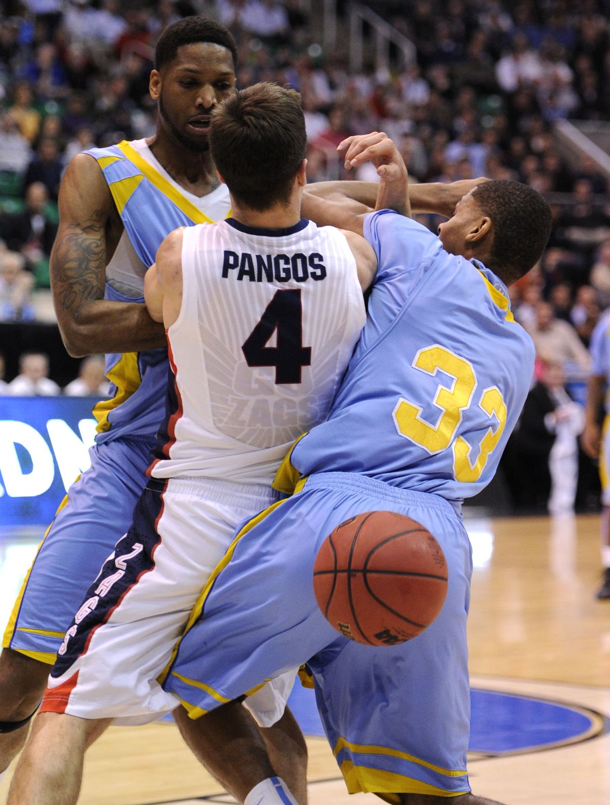 Ball goes its own way as Kevin Pangos tangles with Brandon Moore, left, and Malcolm Miller. (Colin Mulvany)