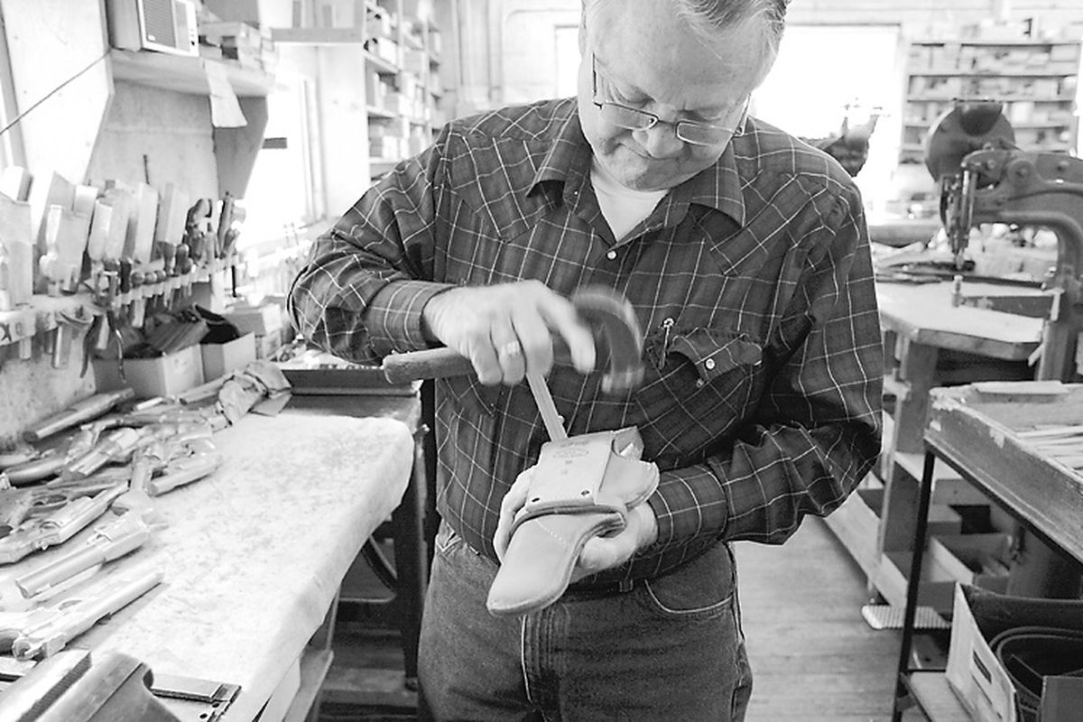 In this May 25 photo, Ben Wetzel, owner of the Idaho Leather Co. in Boise, makes a holster. Wetzel’s shop hearkens back to an era of handcrafted wares. Some of the machines in his shop date to before 1900.  (PHOTOS BY Katherine Jones)