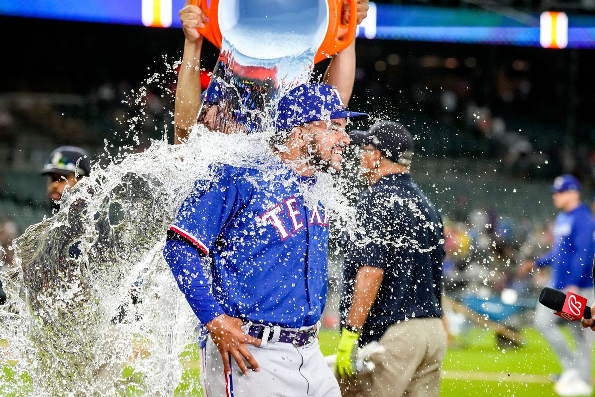 Water is dumped on Grant Anderson of the Texas Rangers while he is interviewed after beating the Detroit Tigers on Tuesday at Comerica Park in Detroit.  (Tribune News Service)