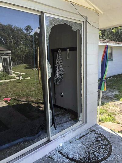 This image provided by the Polk County Sheriff's Office shows the back of the residence where a Polk sheriff's lieutenant entered the house and exchanged fire with a shooting suspect in a neighborhood in Lakeland, Fla. Four people are dead including a mother who was still cradling her now-deceased baby in what Florida sheriff's deputies are calling a massive gunfight early Sunday with a suspect they said was “ready for battle.”  (HOGP)