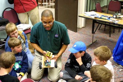 
Mick Bowen, an education specialist with NASA, shows off the inner electronics of a robotic toy in Dillon, Mont., during a Spaceward Bound class. Bowen explained that robots are dependent on people to write programs dictating their function. 
 (Associated Press / The Spokesman-Review)