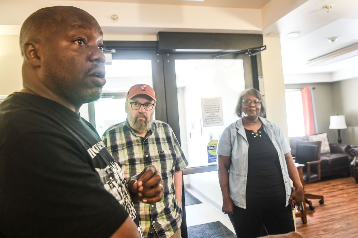 Chauncey Jones, left, talks Friday about housing in East Central along with Chris Venne, center, and the Rev. Betsy Williams at Friendship Gardens.  (Kathy Plonka/The Spokesman-Review)