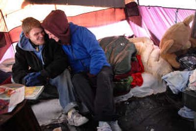 
James Coltson, 19, and his wife, Brandee, 23, share a moment Thursday  in their tent at the homeless camp along Napa Street.  The couple say they will find another spot to pitch camp. 
 (BRIAN PLONKA photos / The Spokesman-Review)
